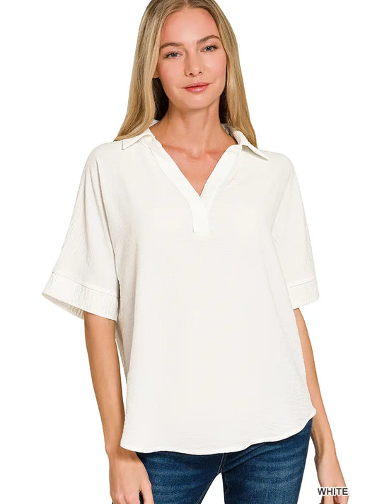 Woman wearing a white blouse with short sleeves on a white background